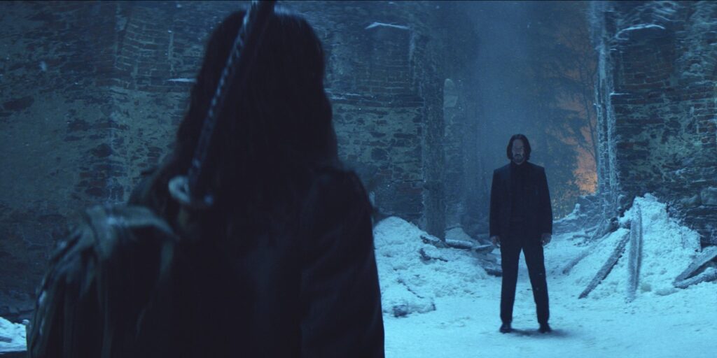 Eve and John Wick standing in the snow in Ballerina